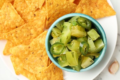 Photo of Delicious salsa with nachos on white table, top view