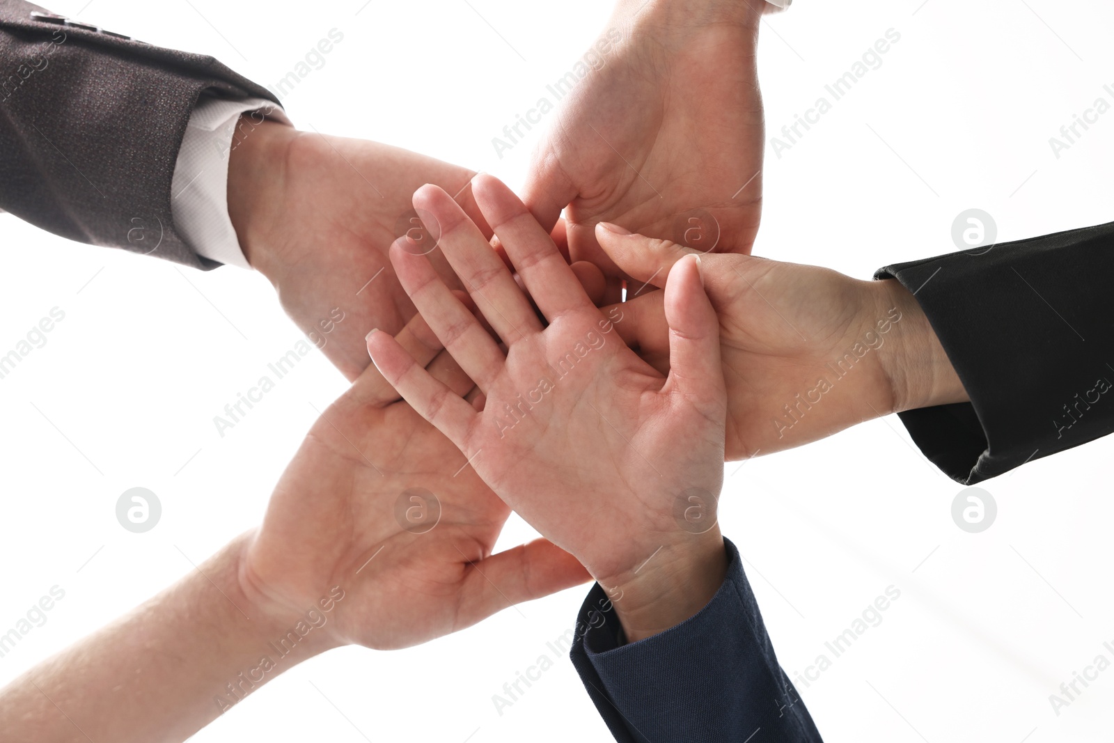 Photo of Teamwork. Group of people joining hands together indoors, bottom view