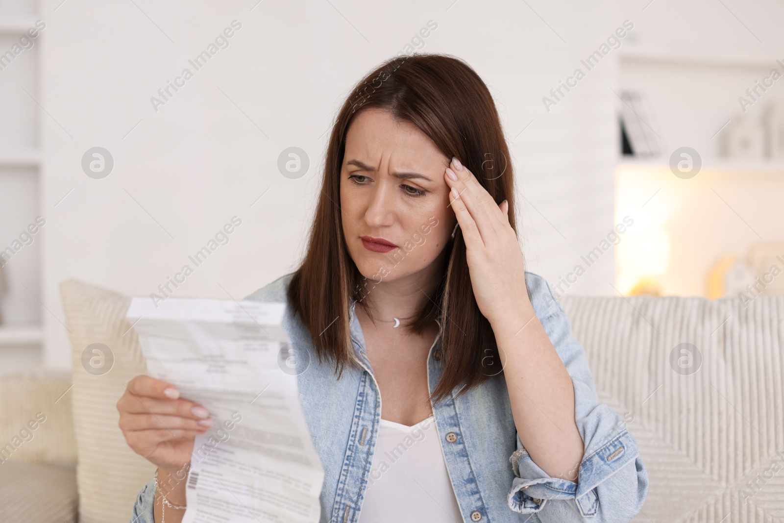 Photo of Worried woman reading pills side effects and instruction indoors