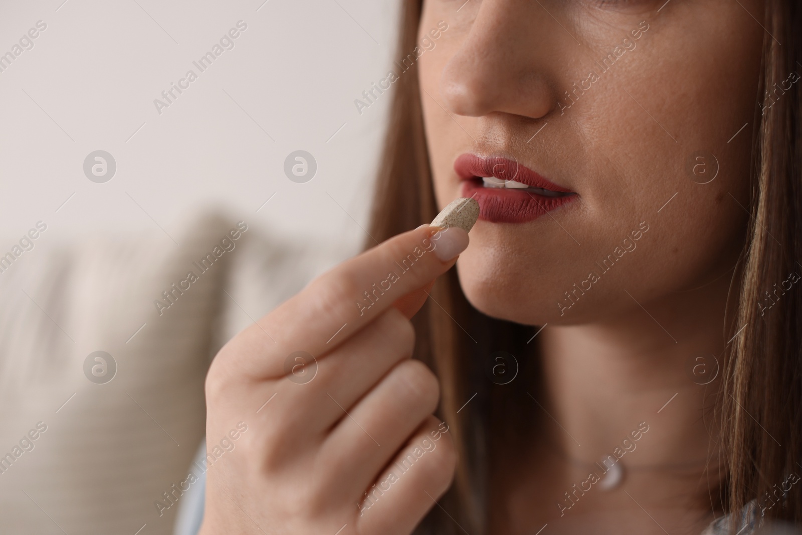 Photo of Woman taking medical pill at home, closeup