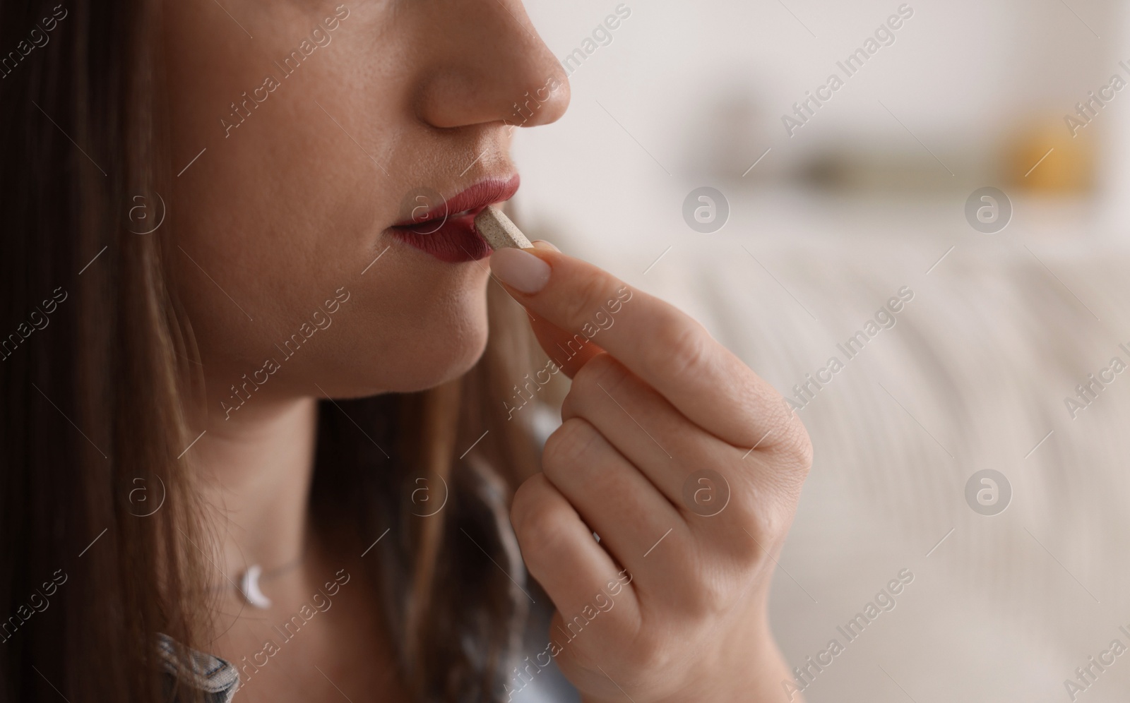 Photo of Woman taking medical pill at home, closeup