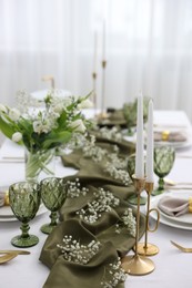 Photo of Color accent table setting with glasses, flowers and olive napkins