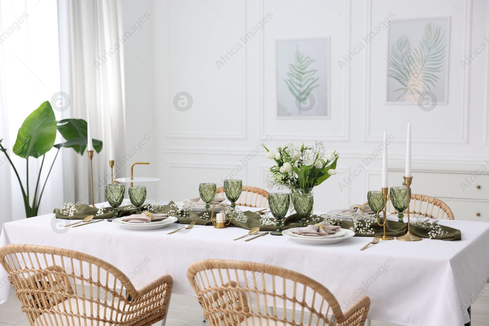 Photo of Color accent table setting with glasses, flowers and olive napkins