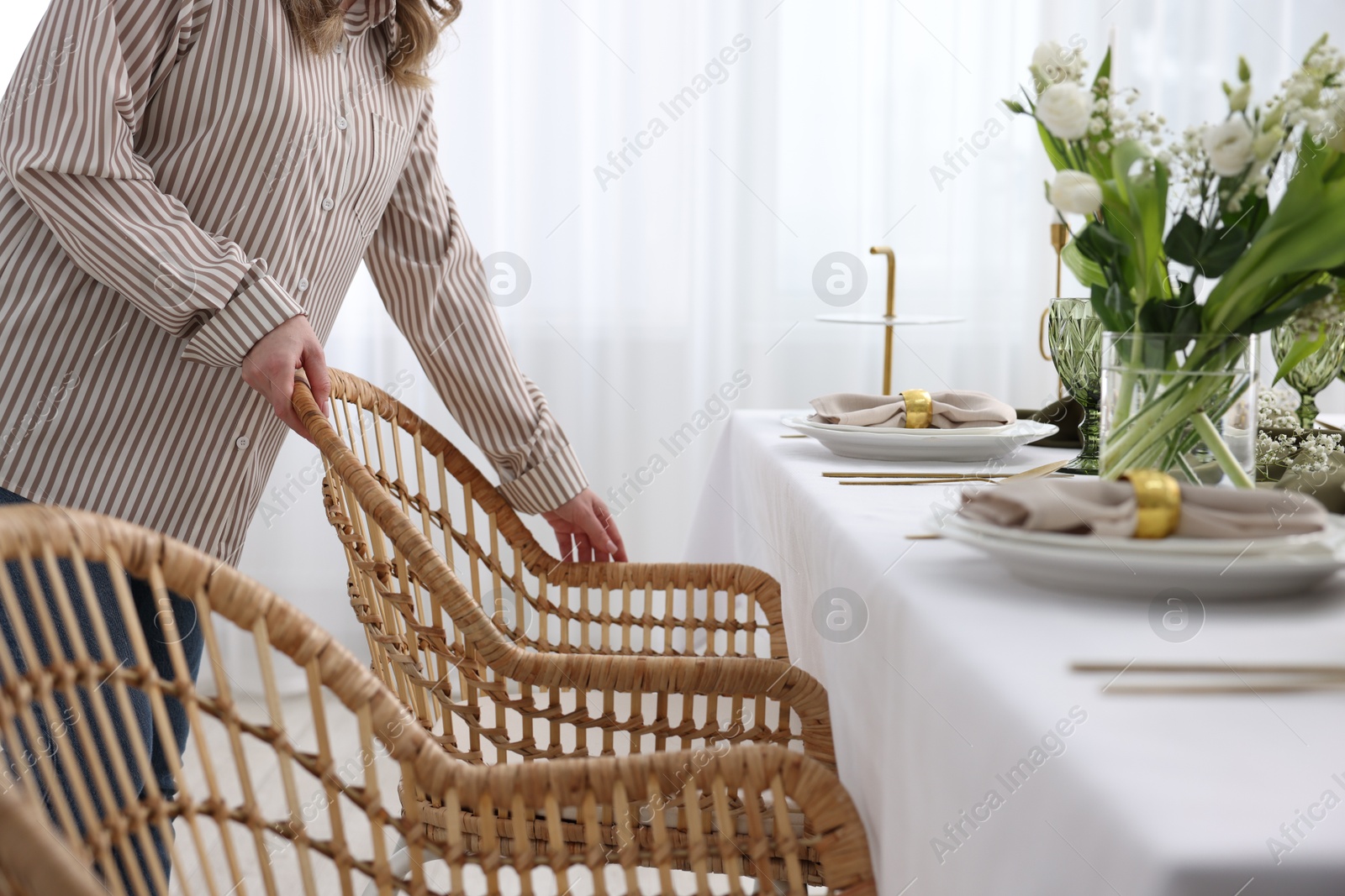 Photo of Young woman setting table for dinner at home, closeup