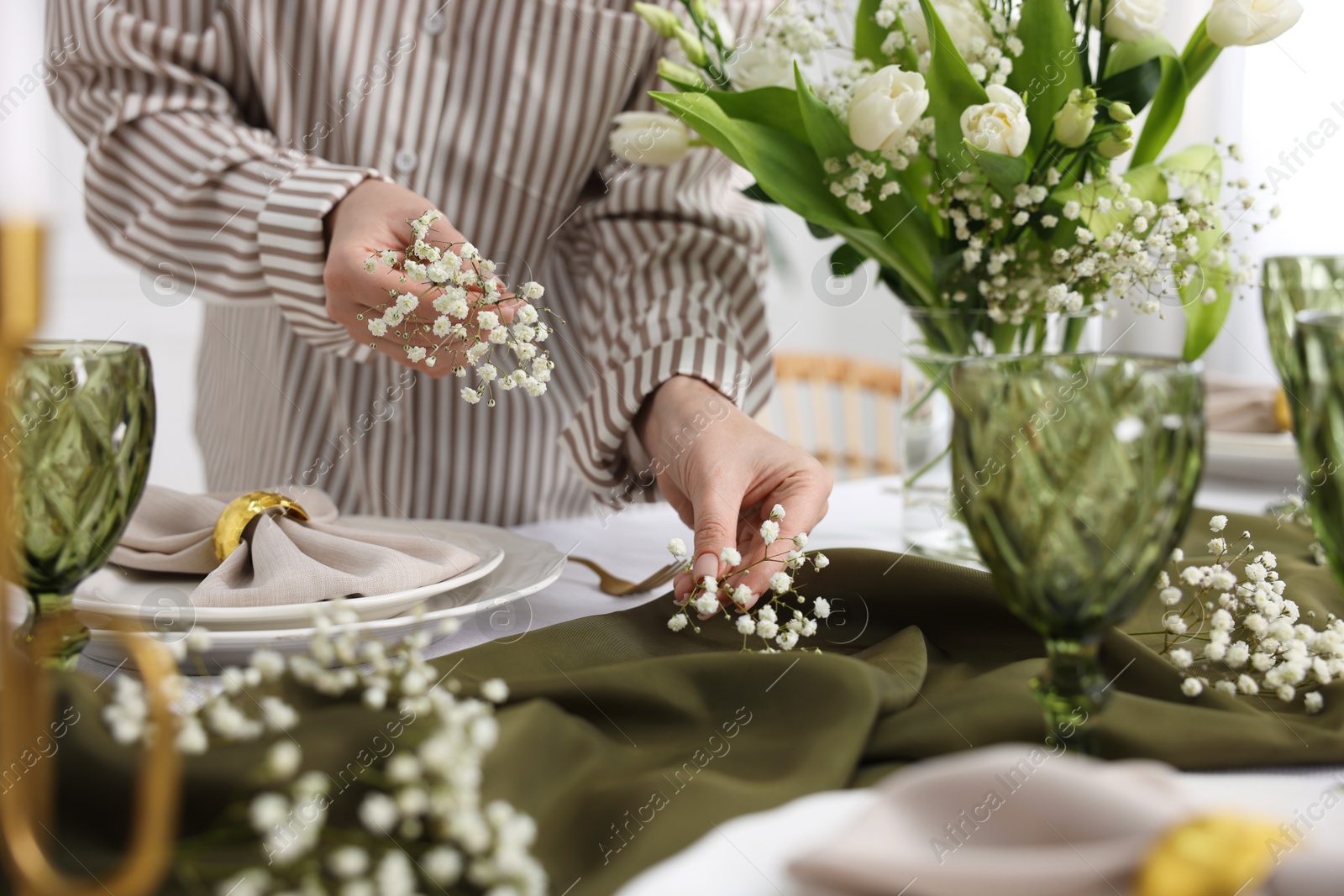 Photo of Young woman setting table for dinner at home, closeup