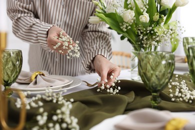 Photo of Young woman setting table for dinner at home, closeup