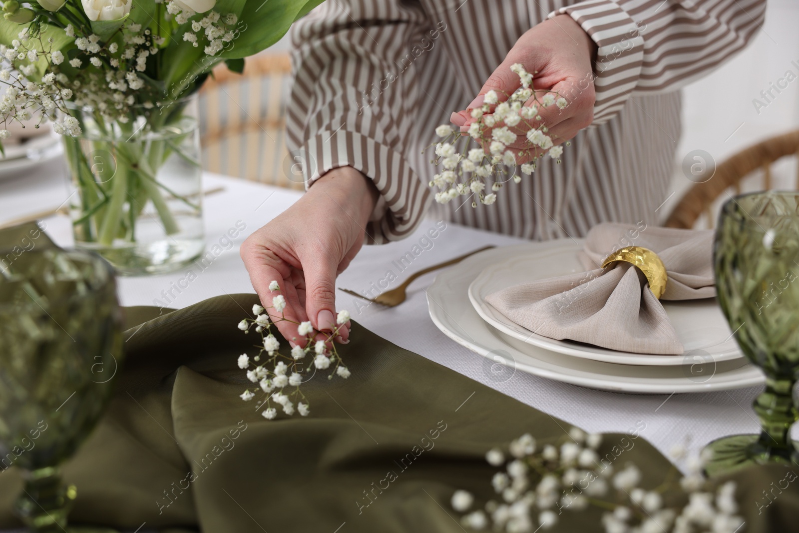 Photo of Young woman setting table for dinner at home, closeup