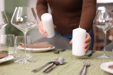 Photo of Young woman setting table for dinner at home, closeup