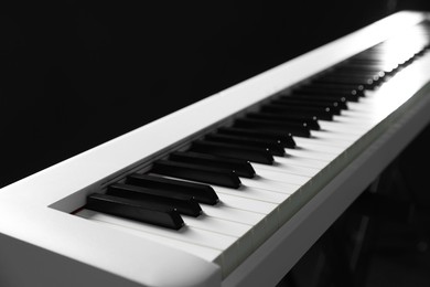 Photo of Synthesizer on black background, closeup. Electronic musical instrument