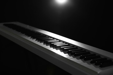 Photo of Synthesizer on black background, closeup. Electronic musical instrument