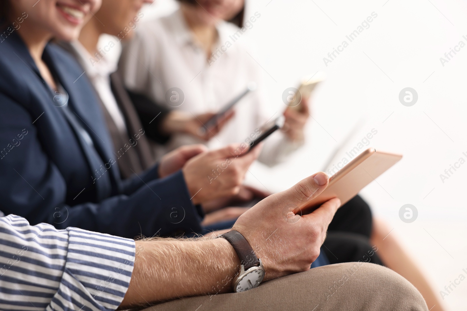 Photo of Group of people using different gadgets indoors, closeup. Modern technology