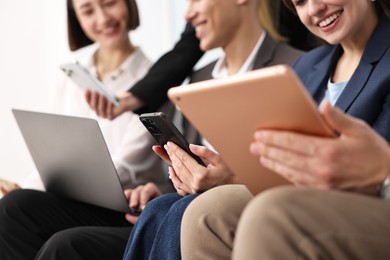 Group of people using different gadgets indoors, closeup. Modern technology