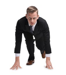 Businessman in starting position for run ready for competition on white background