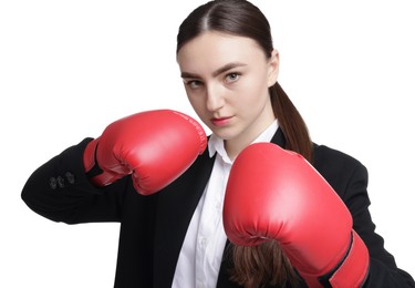 Competition. Businesswoman in suit wearing boxing gloves on white background