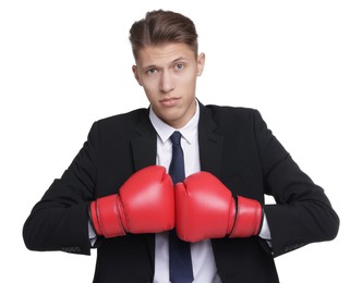 Competition. Businessman in suit wearing boxing gloves on white background