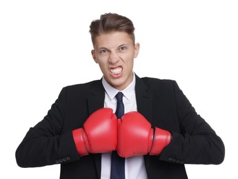 Competition. Angry businessman in suit wearing boxing gloves on white background