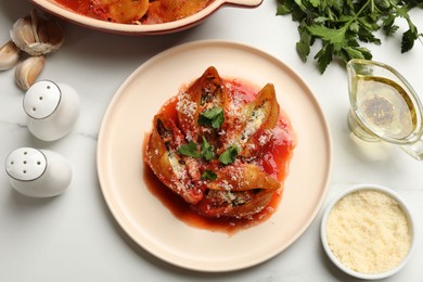 Photo of Delicious conchiglie pasta with ricotta cheese, tomato sauce and parsley on white table, flat lay