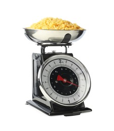 Photo of Mechanical kitchen scale with bowl of raw pasta isolated on white