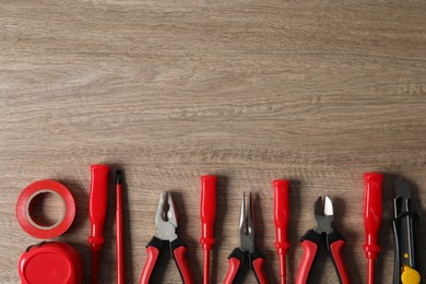 Photo of Different electrical tools on wooden table, flat lay. Space for text