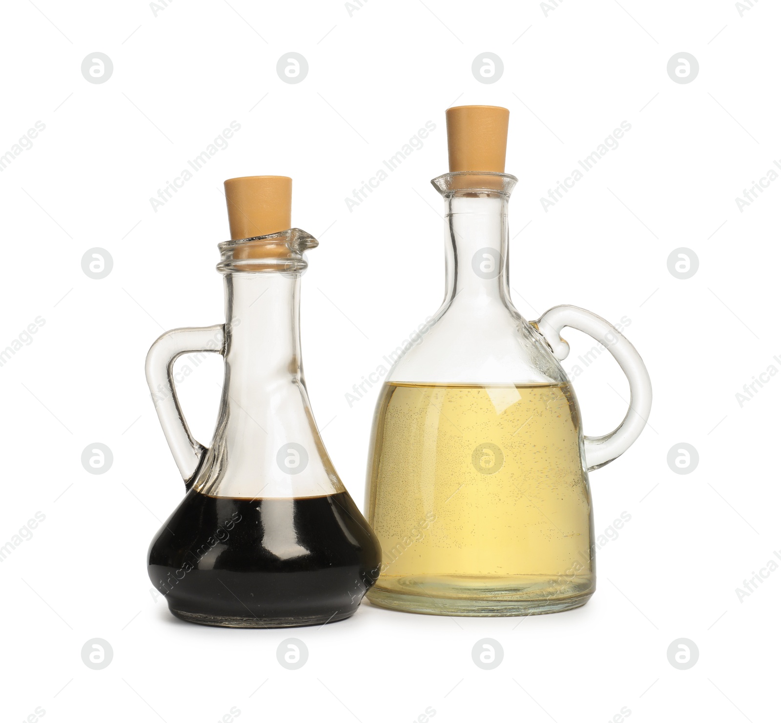 Photo of Salad dressings in bottles isolated on white