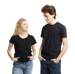 Photo of Young woman and man wearing blank black t-shirts on white background. Mockup for design