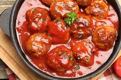 Photo of Delicious meatballs with tomato sauce in baking dish on table, top view