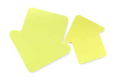 Photo of Two yellow paper arrows isolated on white, top view