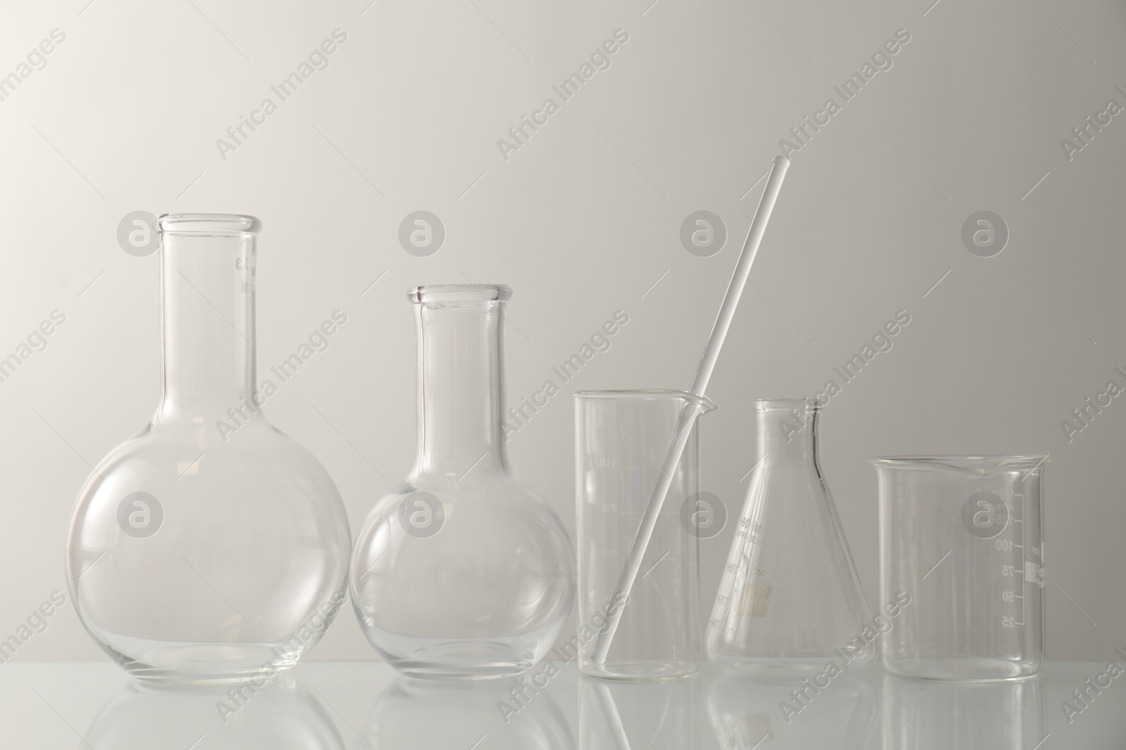 Photo of Many different laboratory glassware on light background