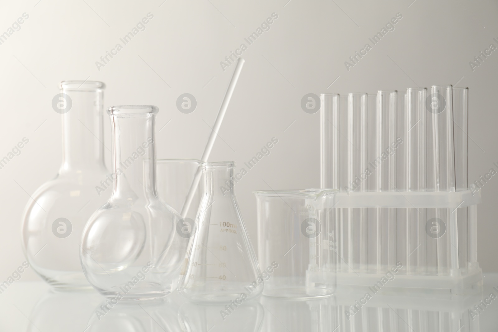 Photo of Many different laboratory glassware on light background