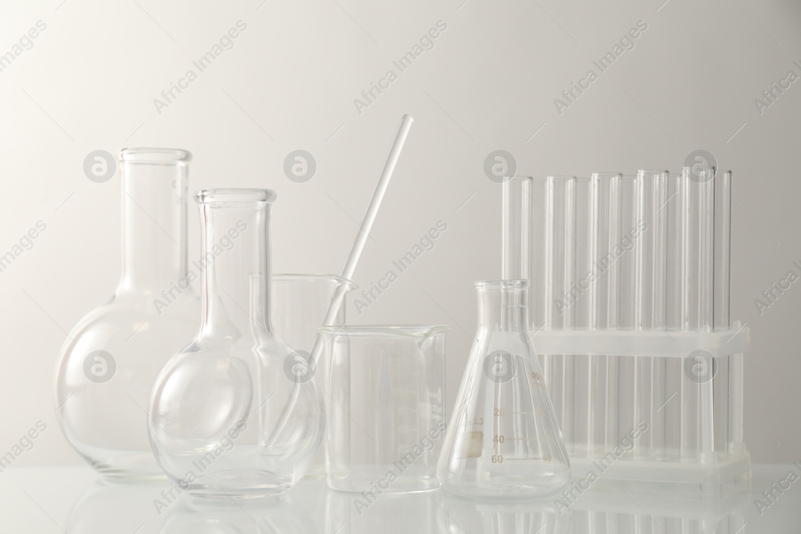 Photo of Many different laboratory glassware on light background