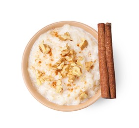 Photo of Tasty rice pudding with walnuts and cinnamon isolated on white, top view