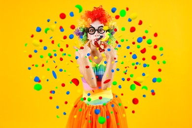 Image of Girl dressed like clown with party blowers under falling confetti on orange background