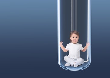 Cute baby in glass test tube on dark blue gradient background. In vitro fertilisation