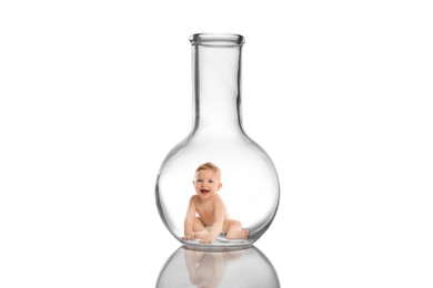 Cute baby in glass flask on white background. In vitro fertilisation