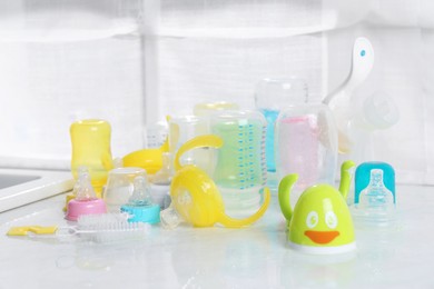 Photo of Clean feeding bottles drying on counter indoors