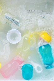 Photo of Washing feeding bottles in sink, top view