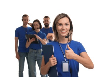 Photo of Technical support call center. Team of friendly operators on white background