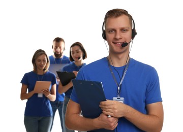 Photo of Technical support call center. Team of friendly operators on white background