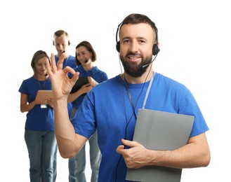 Photo of Technical support call center. Team of friendly operators on white background