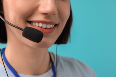 Photo of Technical support call center. Smiling operator on light blue background, closeup