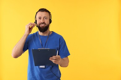 Photo of Technical support call center. Smiling operator with clipboard on yellow background. Space for text