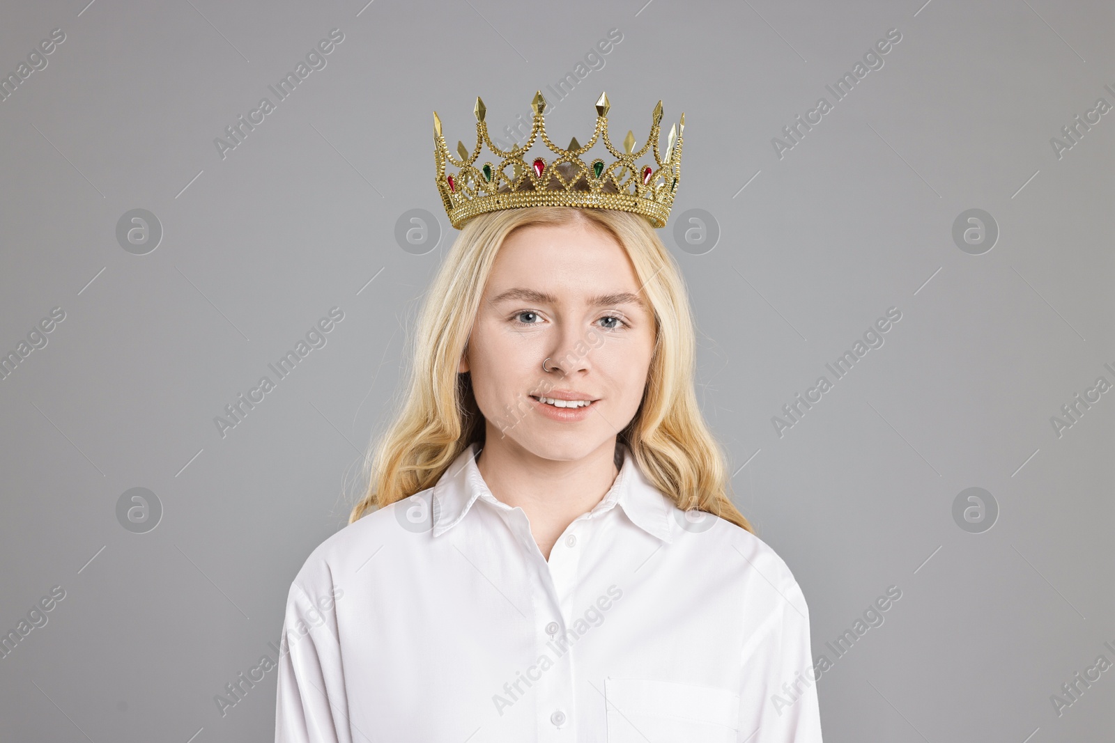 Photo of Happy businesswoman in elegant crown on grey background