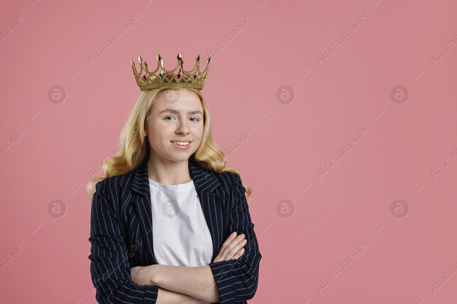 Photo of Smiling businesswoman in elegant crown on dusty pink background. Space for text