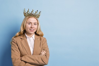 Photo of Smiling businesswoman in elegant crown on light blue background. Space for text