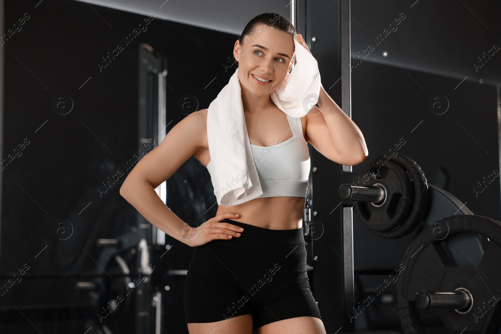 Photo of Happy woman with terry towel in gym