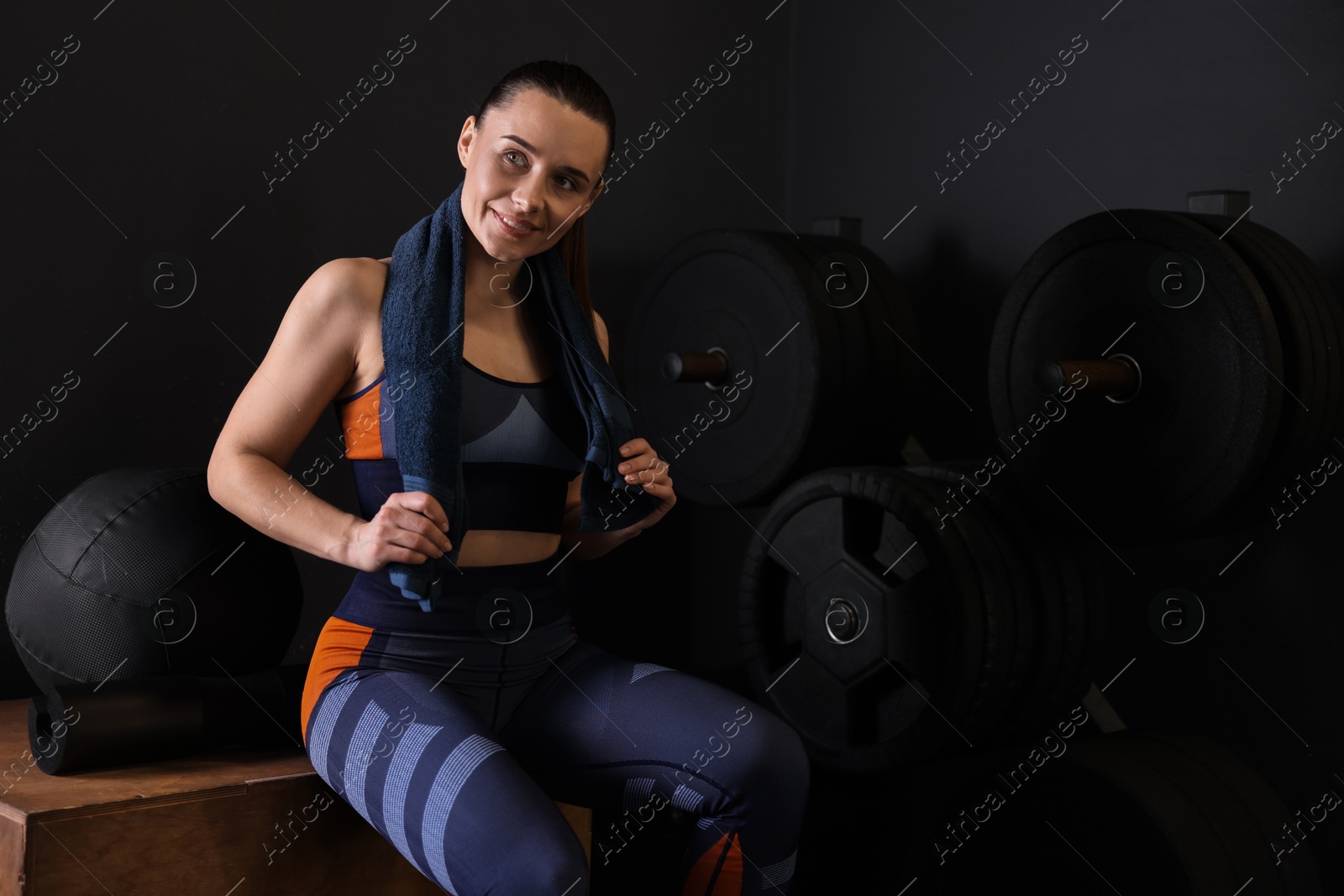 Photo of Happy woman with terry towel in gym