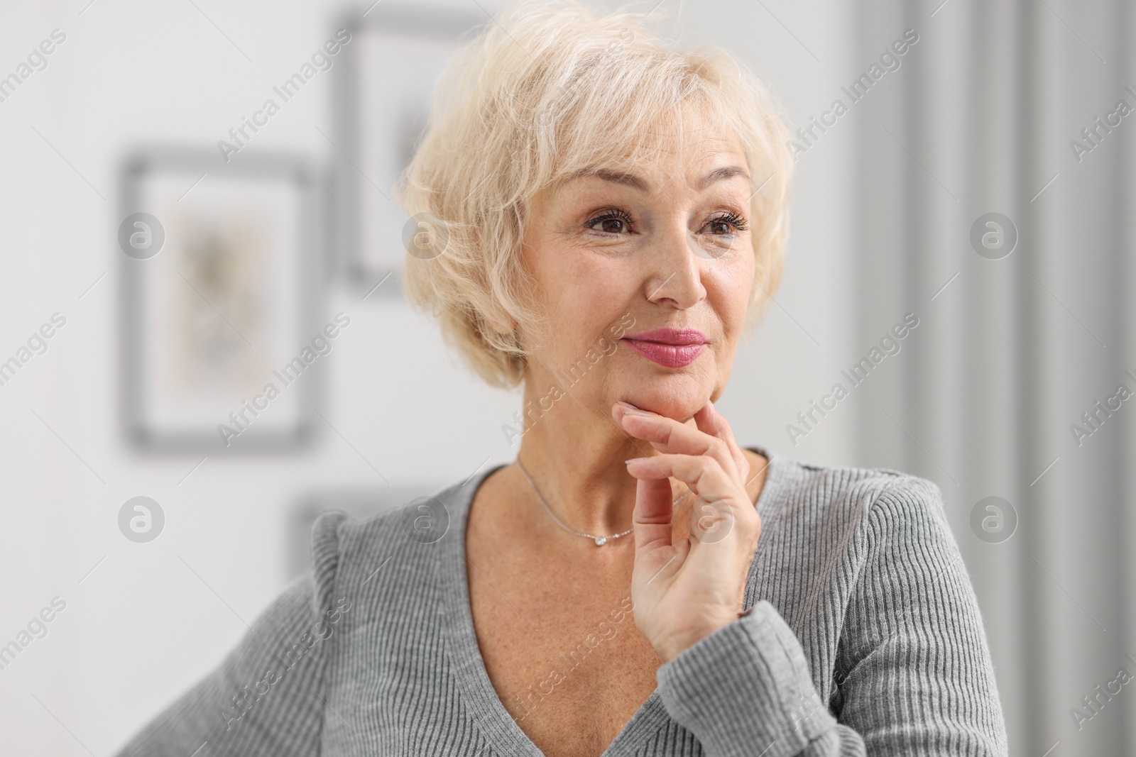 Photo of Portrait of grandmother with beautiful makeup at home