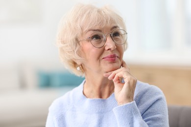 Portrait of beautiful grandmother in glasses at home