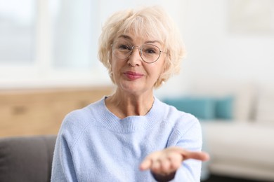 Photo of Portrait of grandmother with beautiful makeup at home