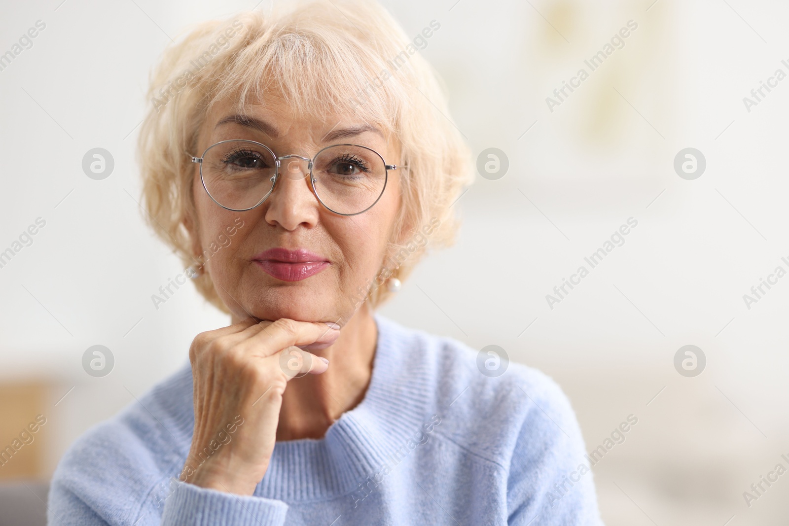 Photo of Portrait of grandmother in glasses at home. Space for text